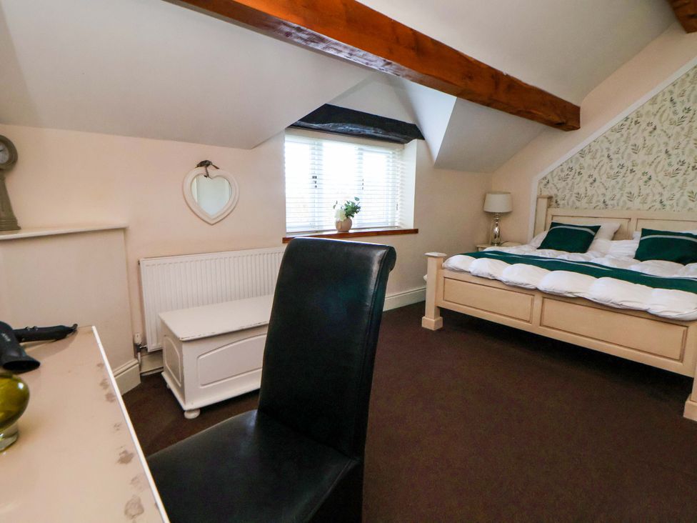 A bedroom with a bed and desk at Home Farm St Asaph
