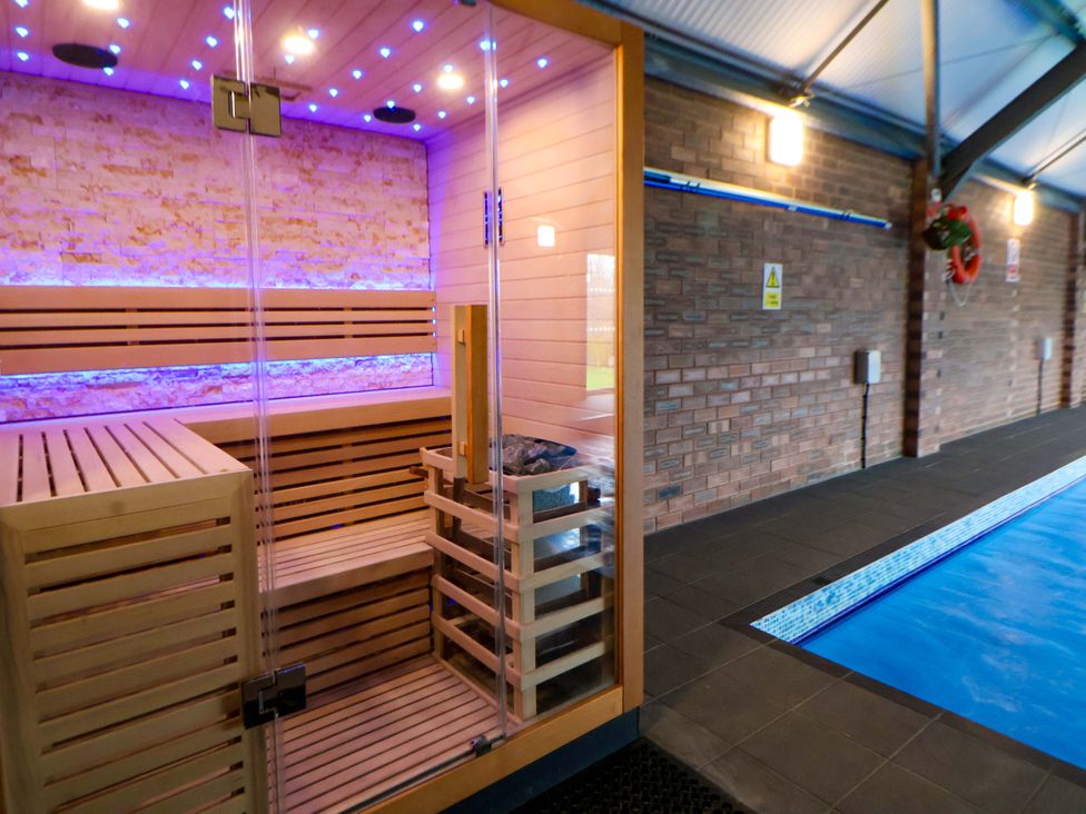 A sauna adjacent to a swimming pool at Home Farm St Asaph