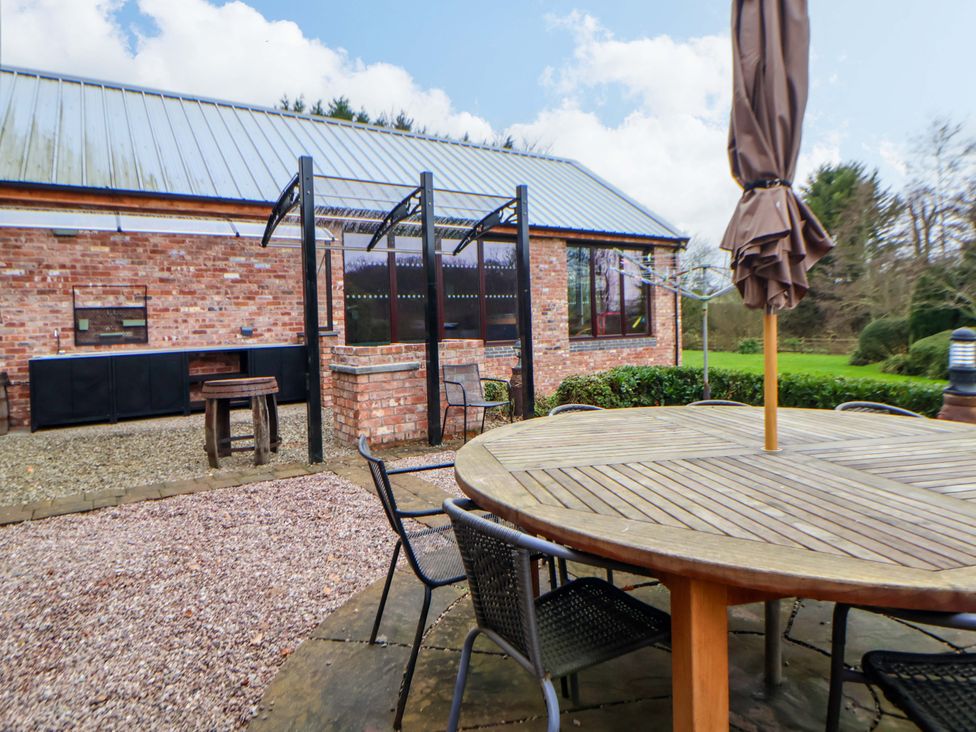 An outdoor area with a table and chairs at Home Farm St Asaph