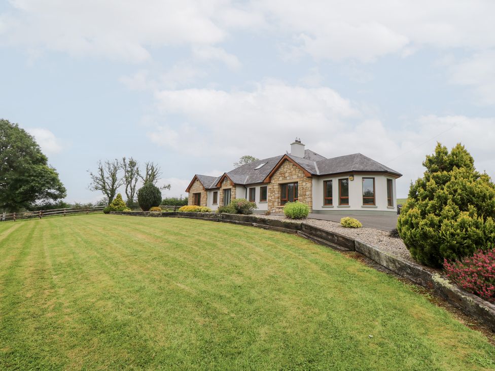 A house with a lawn and trees at Swan Lake in Cloonshaghan near Boyle, County Roscommon