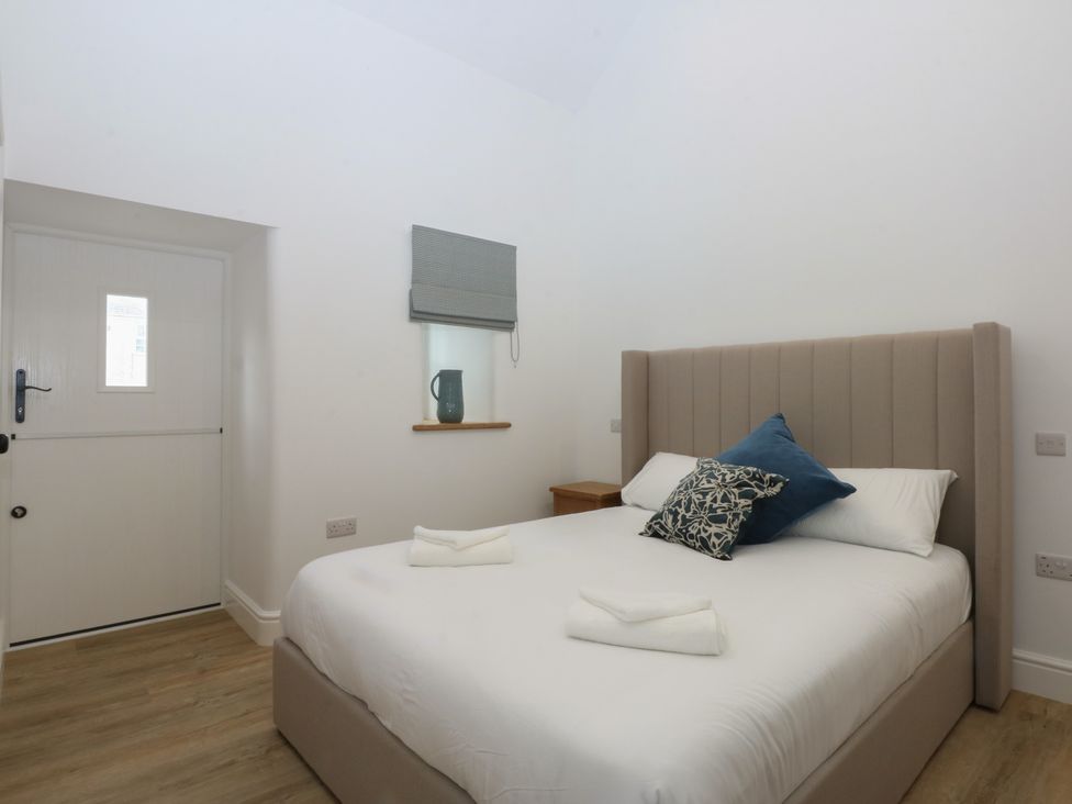 A bedroom with a bed and a window at Beudy