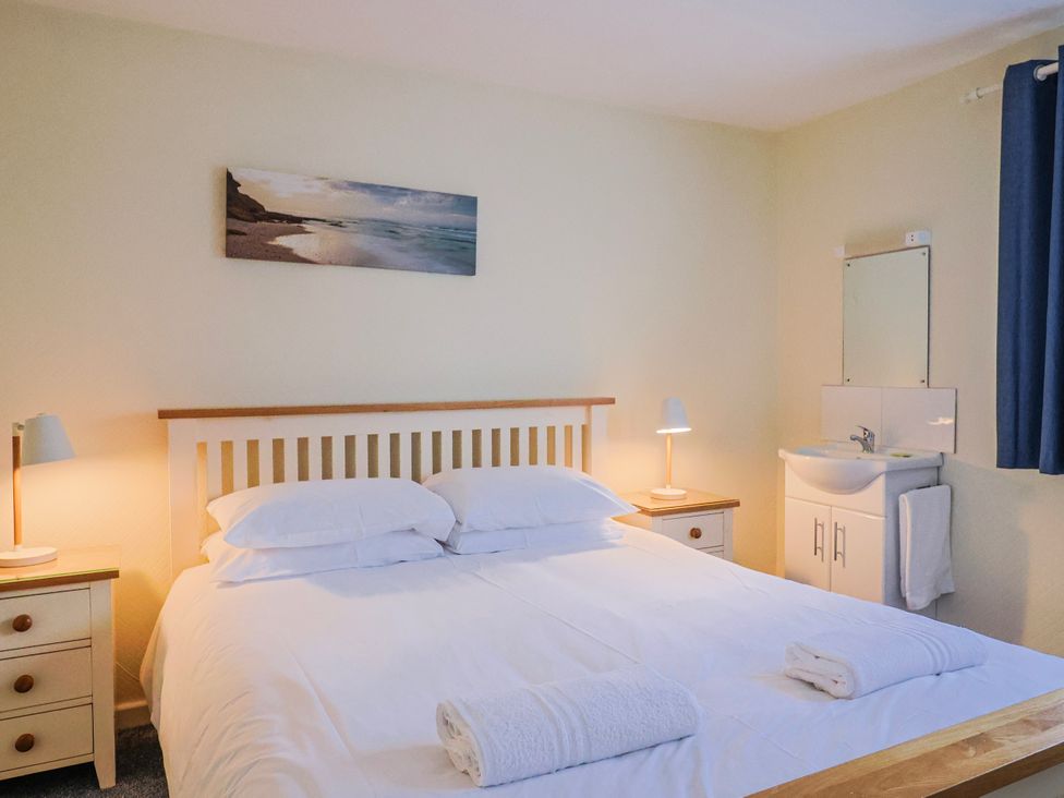 A bedroom with a bed and nightstands at Sea Lovers in Exmouth