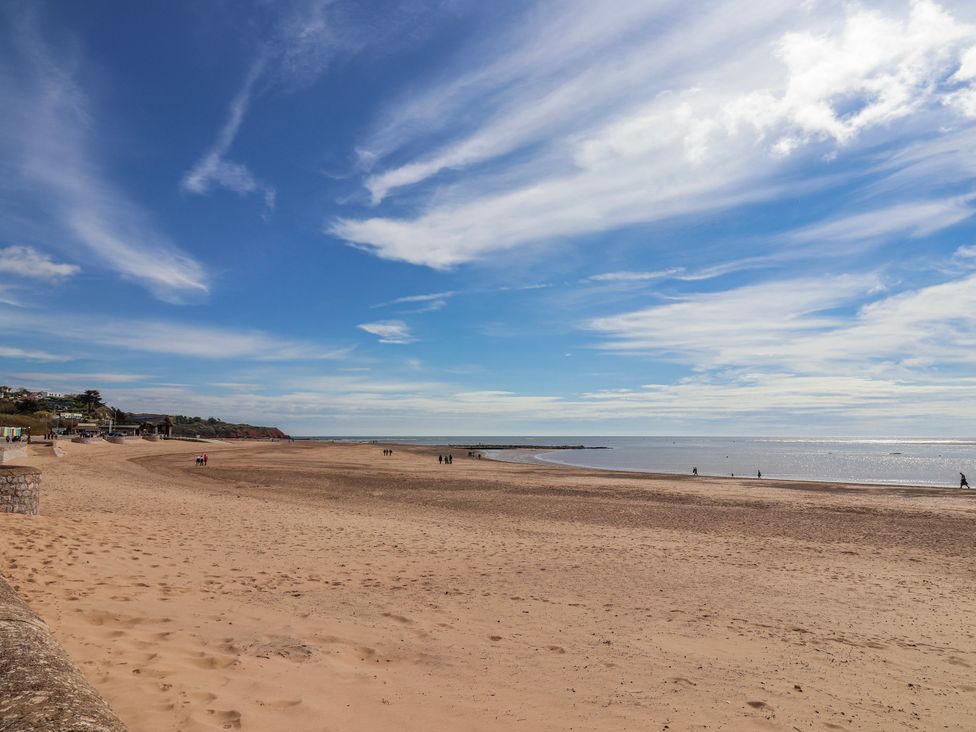 A beach with people walking at Sea Lovers in Exmouth