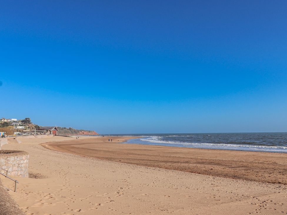 A beach scene with sand and water at Sea Lovers in Exmouth