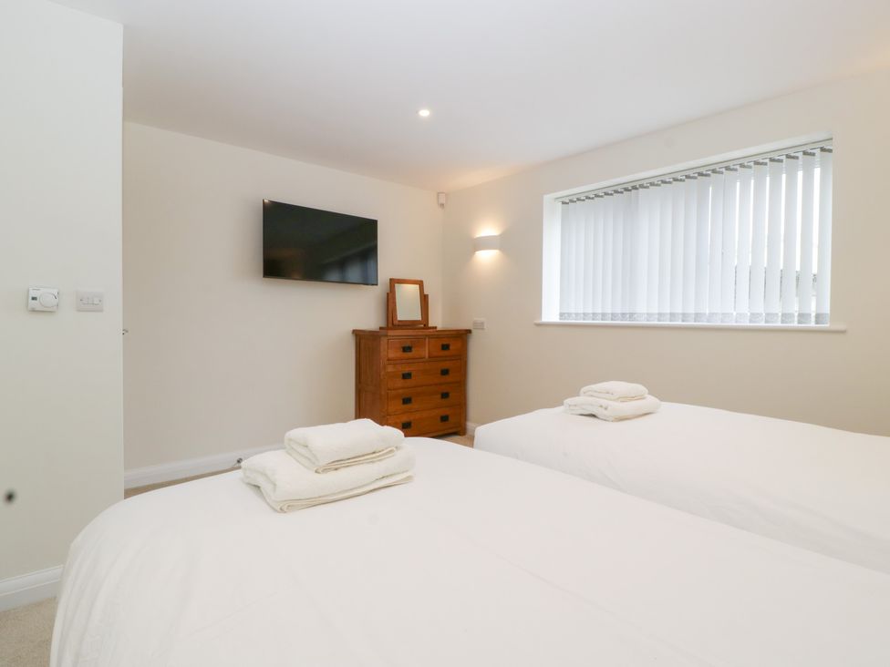 A bedroom with two beds and a television at Hidden Well in Aust