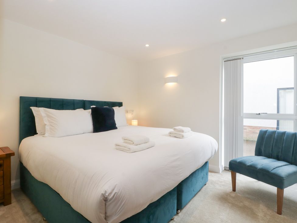 A bedroom with a bed and a chair at Hidden Well in Aust