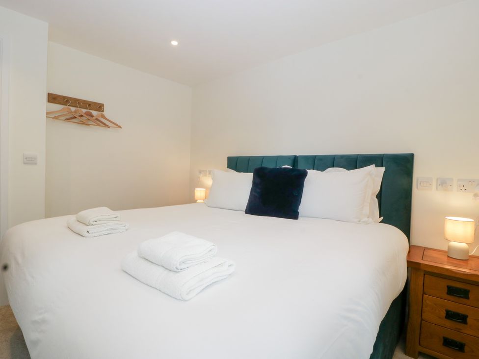 A bedroom with a bed and bedside lamp at Hidden Well in Aust