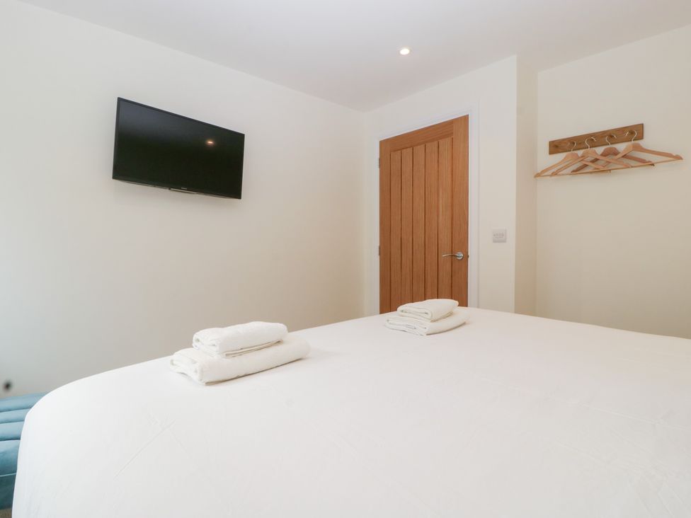 A bedroom with a bed and television at Hidden Well in Aust