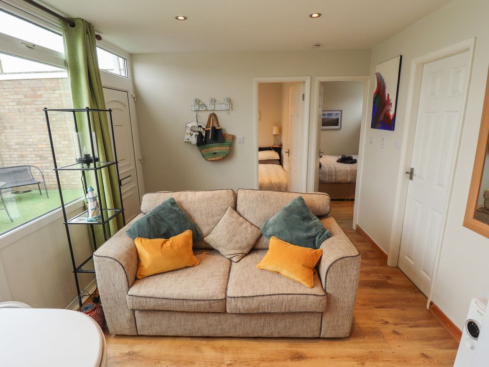 A living room with a couch and shelves at Seaside Retreat near Chapel Point near Chapel St Leonards