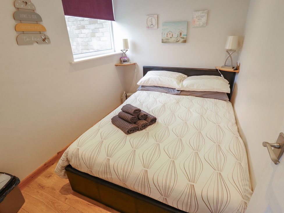 A bedroom with a bed and bedside table at Seaside Retreat near Chapel Point near Chapel St Leonards