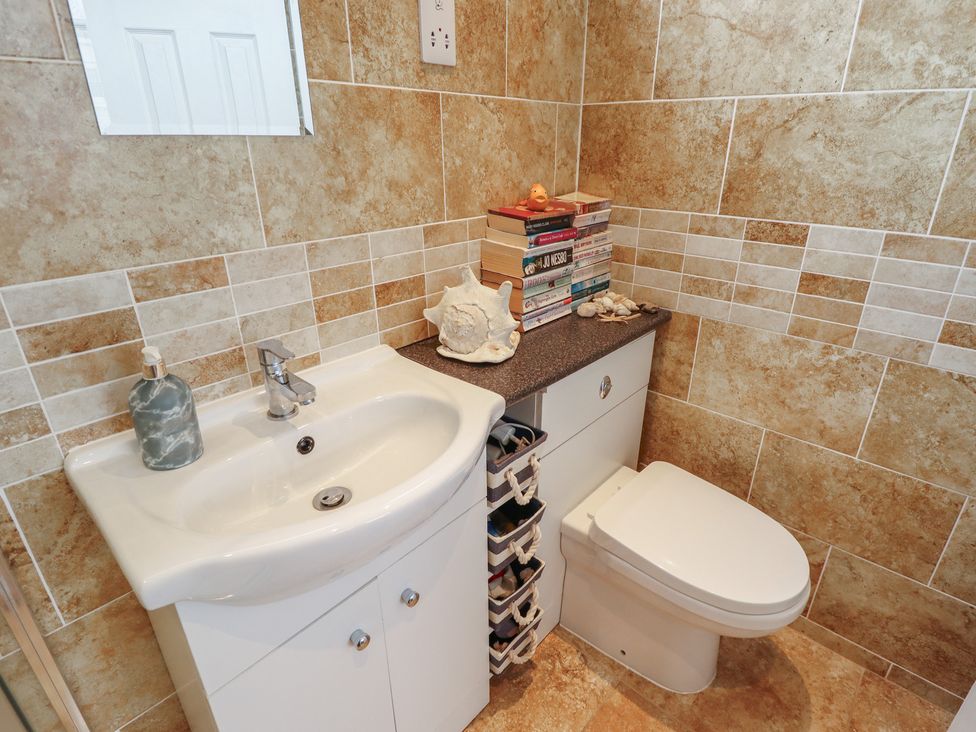 A bathroom with a sink and toilet at Seaside Retreat Chapel Point near Chapel St Leonards