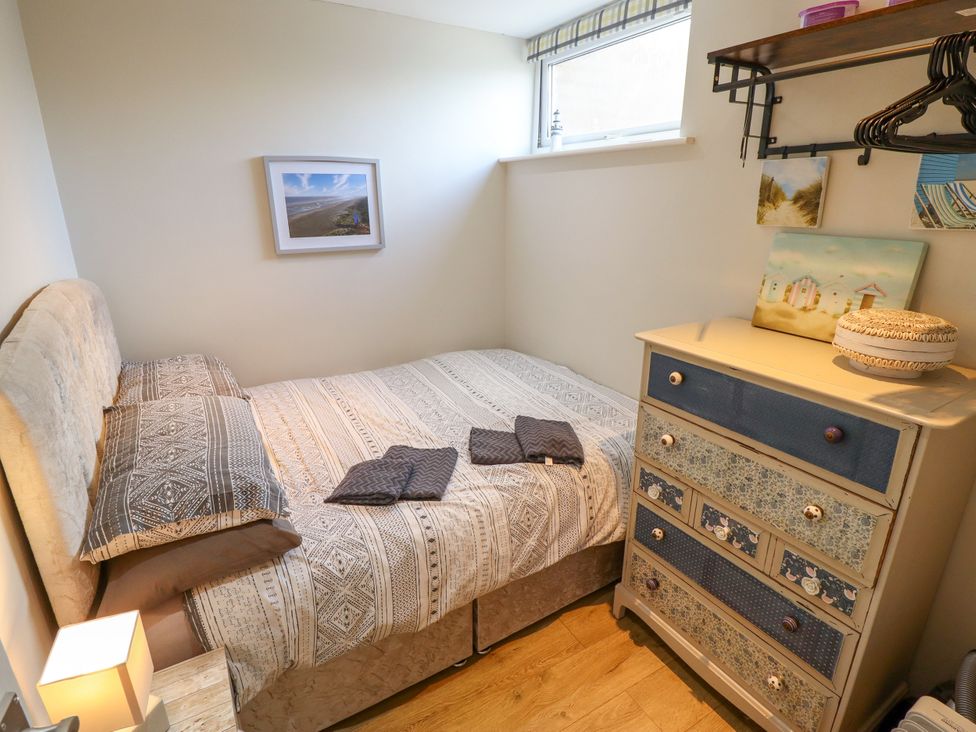 A bedroom with a bed and dresser at Seaside Retreat Chapel Point near Chapel St Leonards