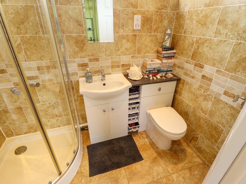 A bathroom with a shower, sink, and toilet at Seaside Retreat Chapel Point near Chapel St Leonards