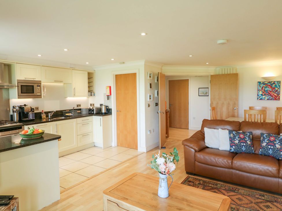 A kitchen with seating area including a sofa and dining table at 5 Thurlestone Beach Thurlestone