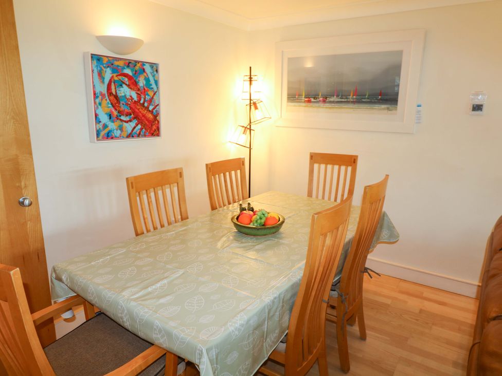 A dining room with a table and chairs at 5 Thurlestone Beach in Thurlestone