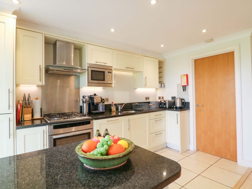 A kitchen with appliances and a fruit bowl at 5 Thurlestone Beach in Thurlestone
