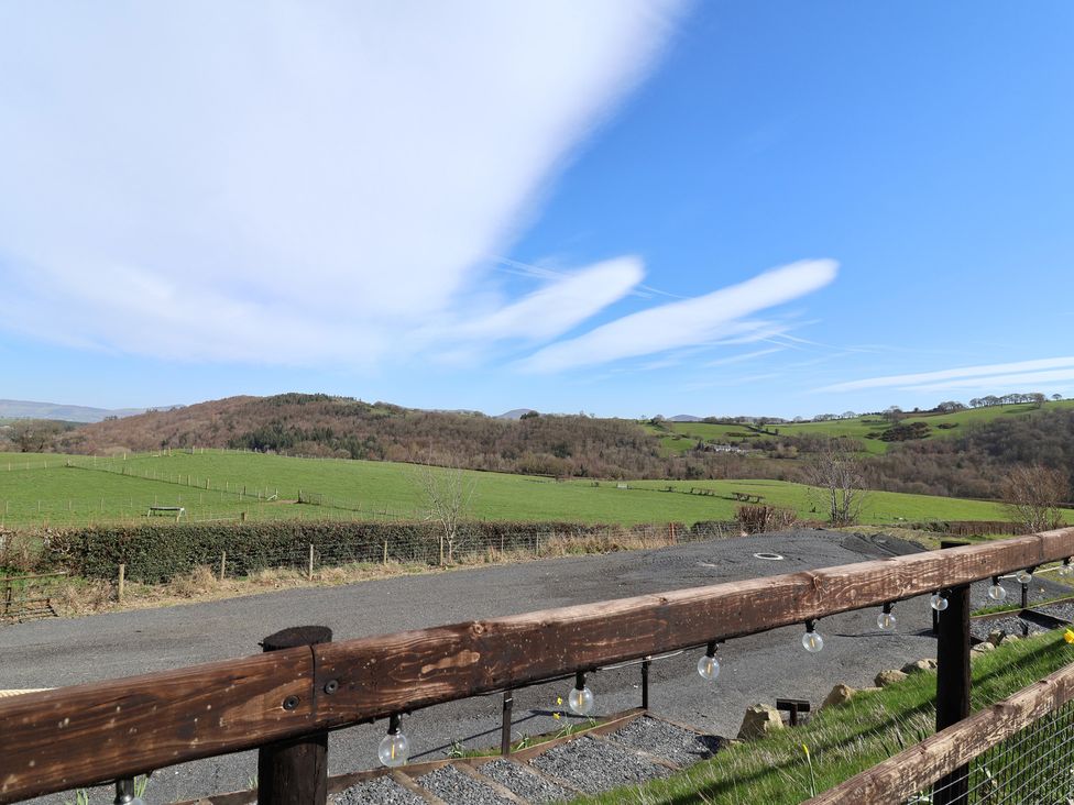 A landscape view with grass and mountains at Lili Wen Fach in Ruthin