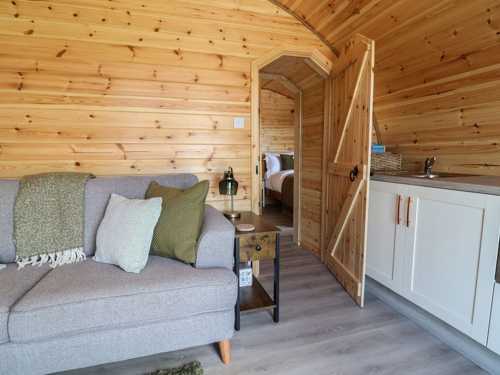 A living room with a sofa and side table at Lili Wen Fach in Ruthin