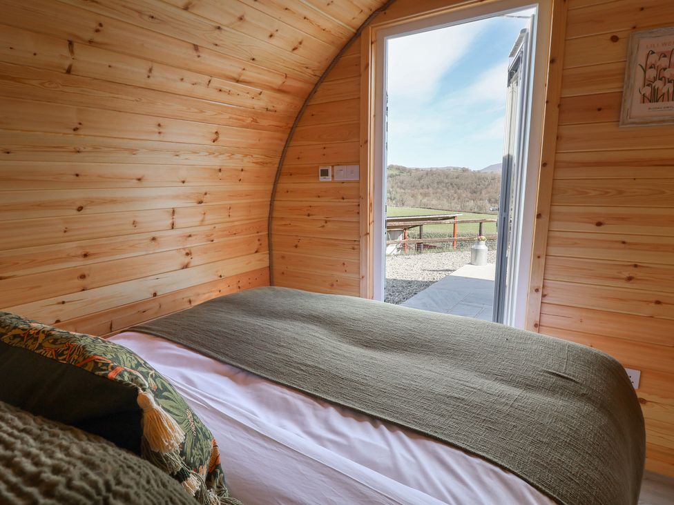A bedroom with a view of the outdoors at Lili Wen Fach in Ruthin