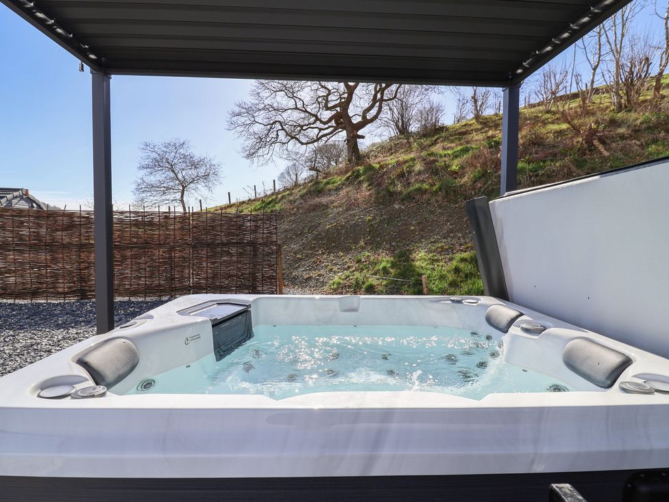 A hot tub in an outdoor area at Lili Wen Fach in Ruthin