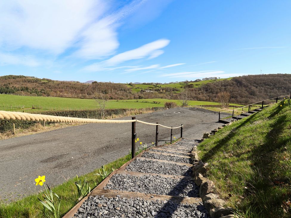 A staircase with a gravel pathway leading to an outdoor area at Lili Wen Fach Ruthin