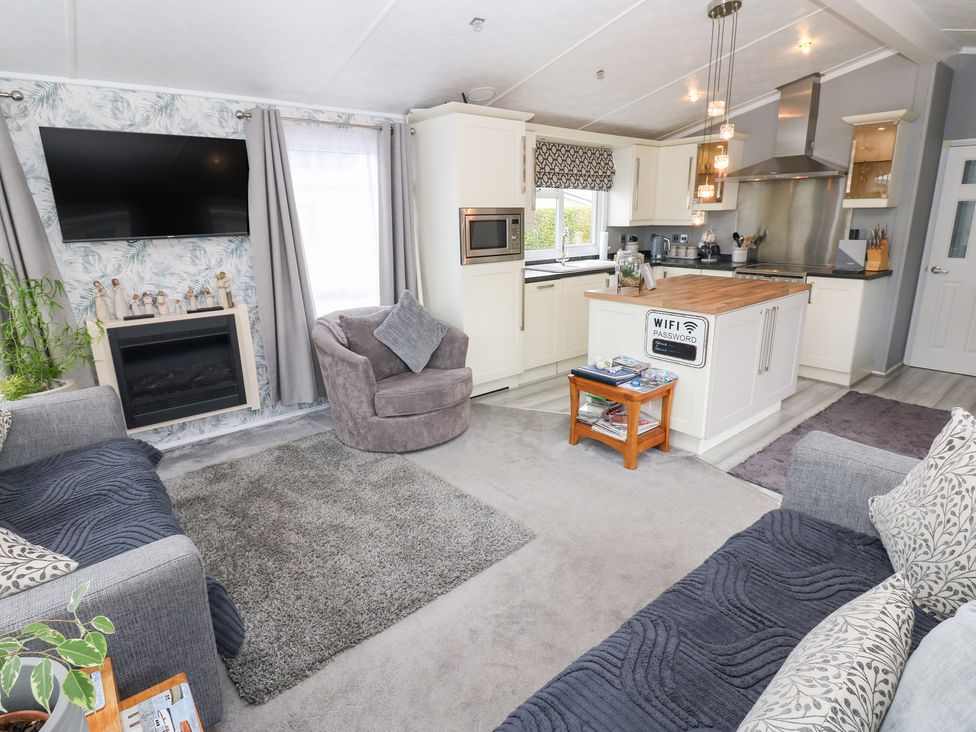 A living room with a sofa and armchair at A and C Lodge-Plot 21 Armathwaite