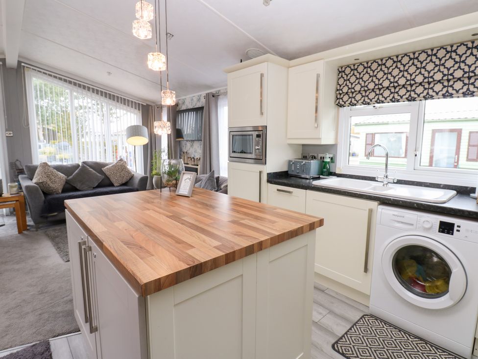 A kitchen with a wooden island and appliances at A and C Lodge-Plot 21 Armathwaite