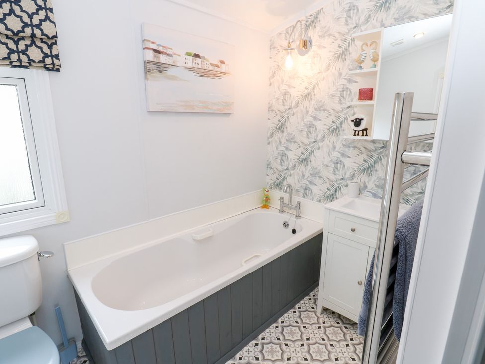 A bathroom with a bath tub and sink at A and C Lodge-Plot 21 Armathwaite