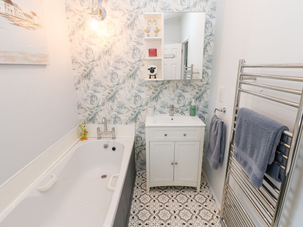 A bathroom with a bathtub and sink at A and C Lodge-Plot 21 Armathwaite