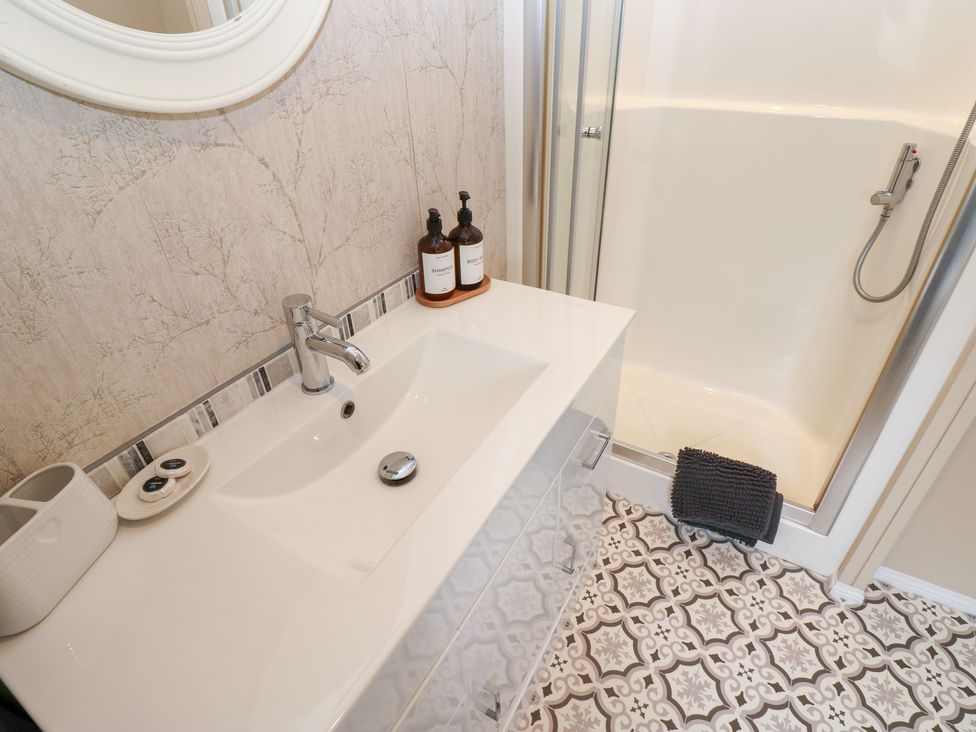 A bathroom with a sink and shower at A and C Lodge-Plot 21 Armathwaite