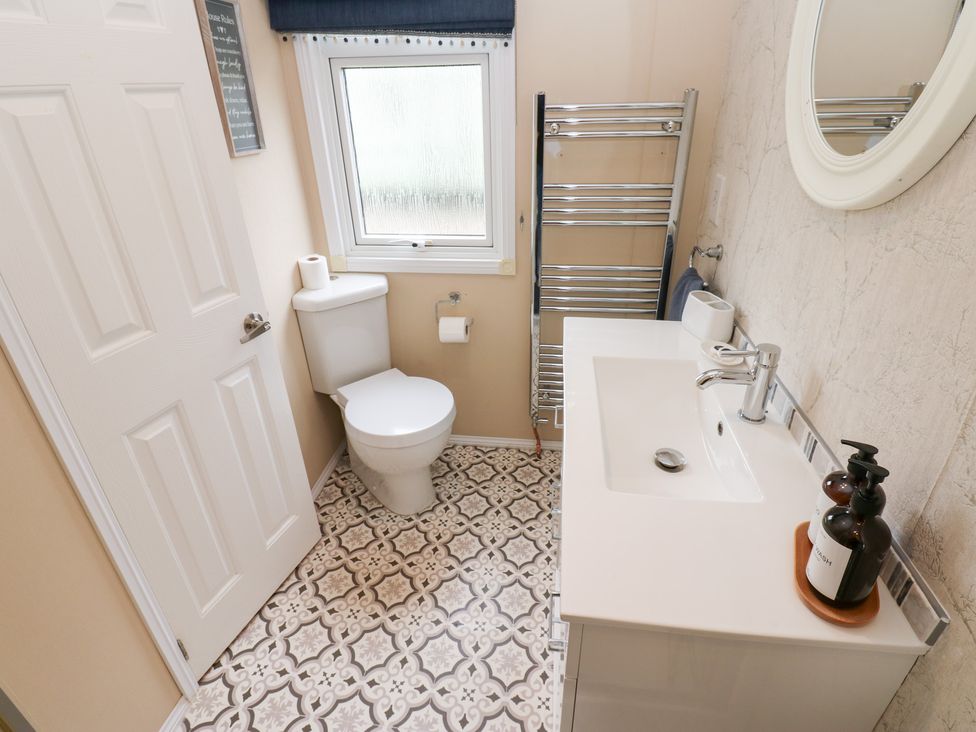 A bathroom with a toilet and sink at A and C Lodge-Plot 21 Armathwaite