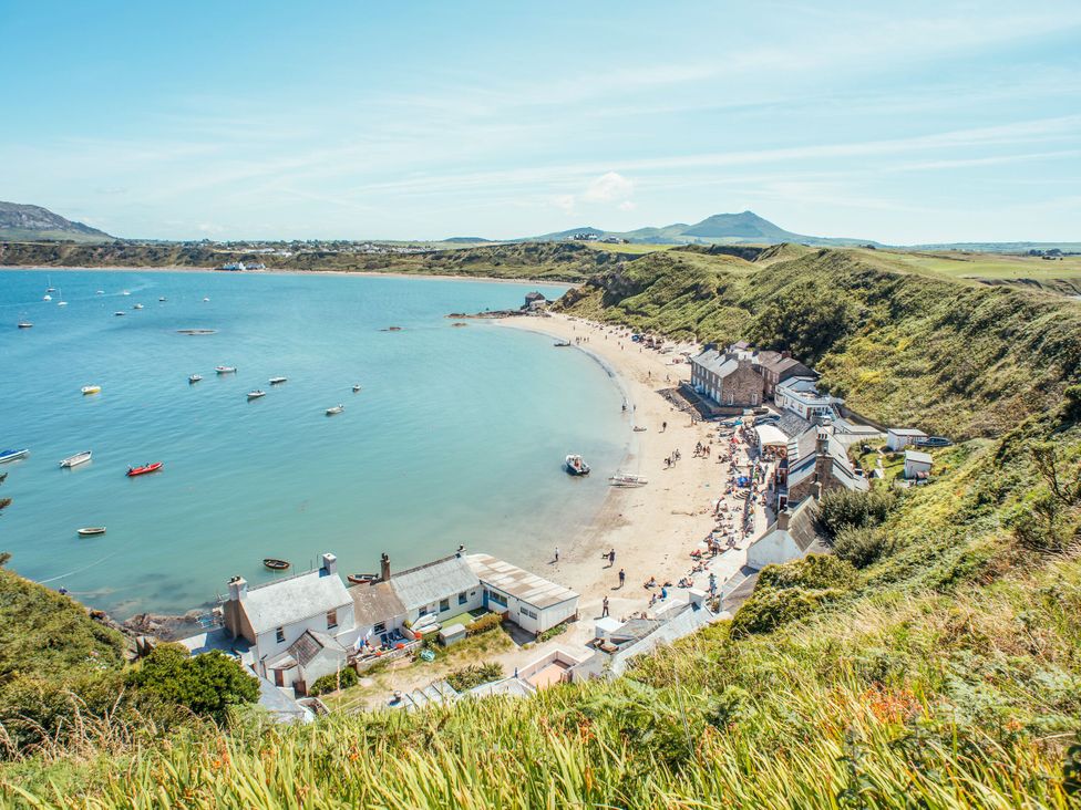 A coastal view with boats and a beach at Seaviews in Nefyn