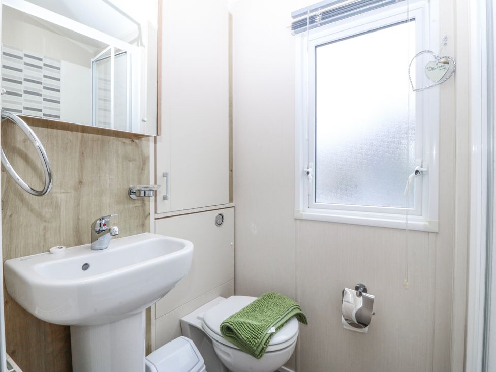 A bathroom with a sink and toilet at Seaviews in Nefyn