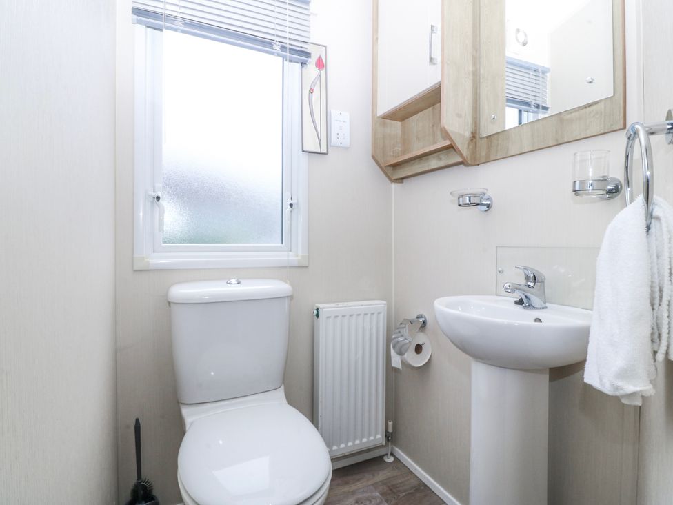 A bathroom with a toilet and washbasin at Seaviews in Nefyn