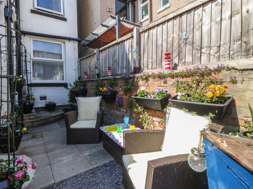 A garden with outdoor furniture and planters at Yr Angor (The Anchor) Llandudno Junction