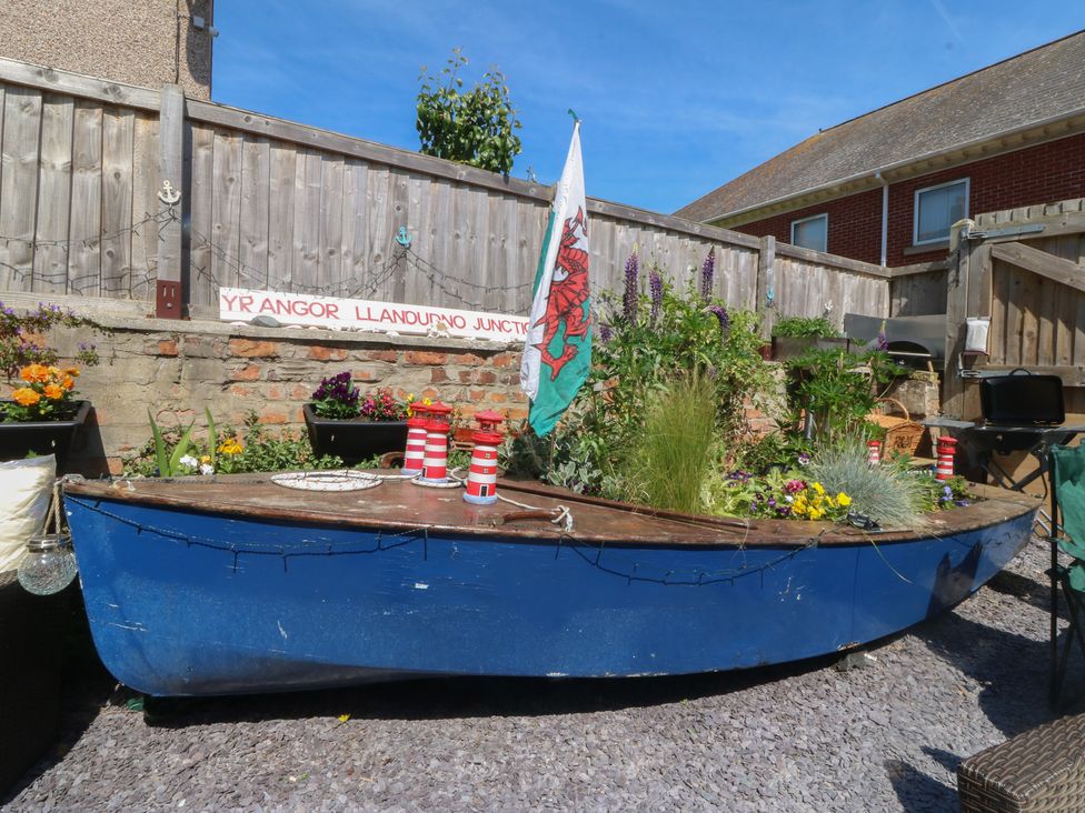 A boat decorated with flowers and a flag at Yr Angor Llandudno Junction