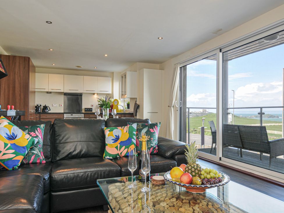 A living room with a couch and coffee table at Whitewater Seaview in Newquay