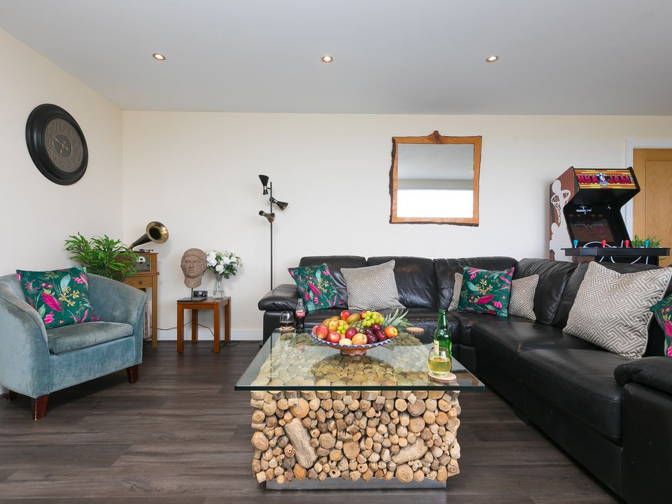 A living room with a sofa and a coffee table at Whitewater Seaview in Newquay