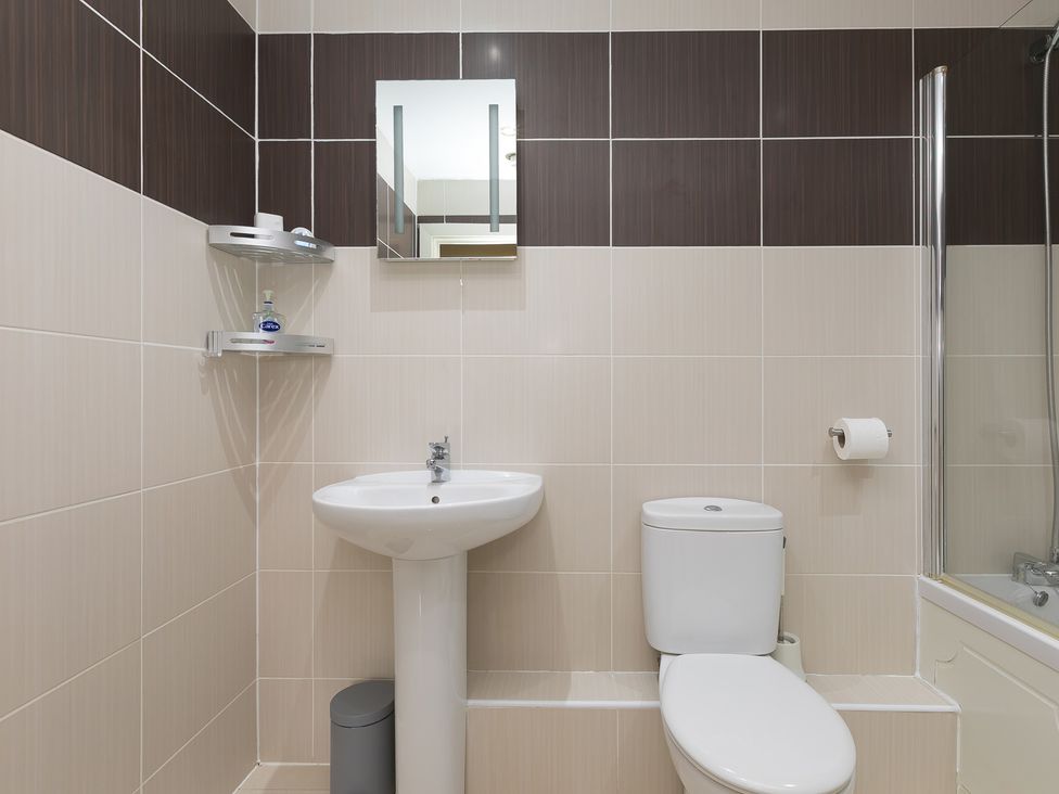 A bathroom with a sink and toilet at Whitewater Seaview in Newquay