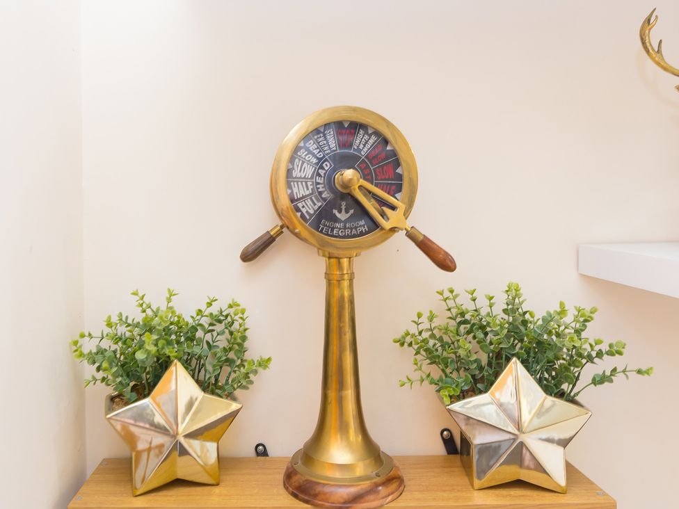 A decorative telegraph and plants at Whitewater Seaview in Newquay