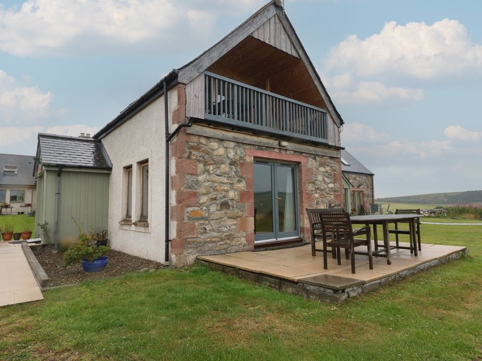 A house with a patio and dining set at Taffs Barn Fortrose near Rosemarkie