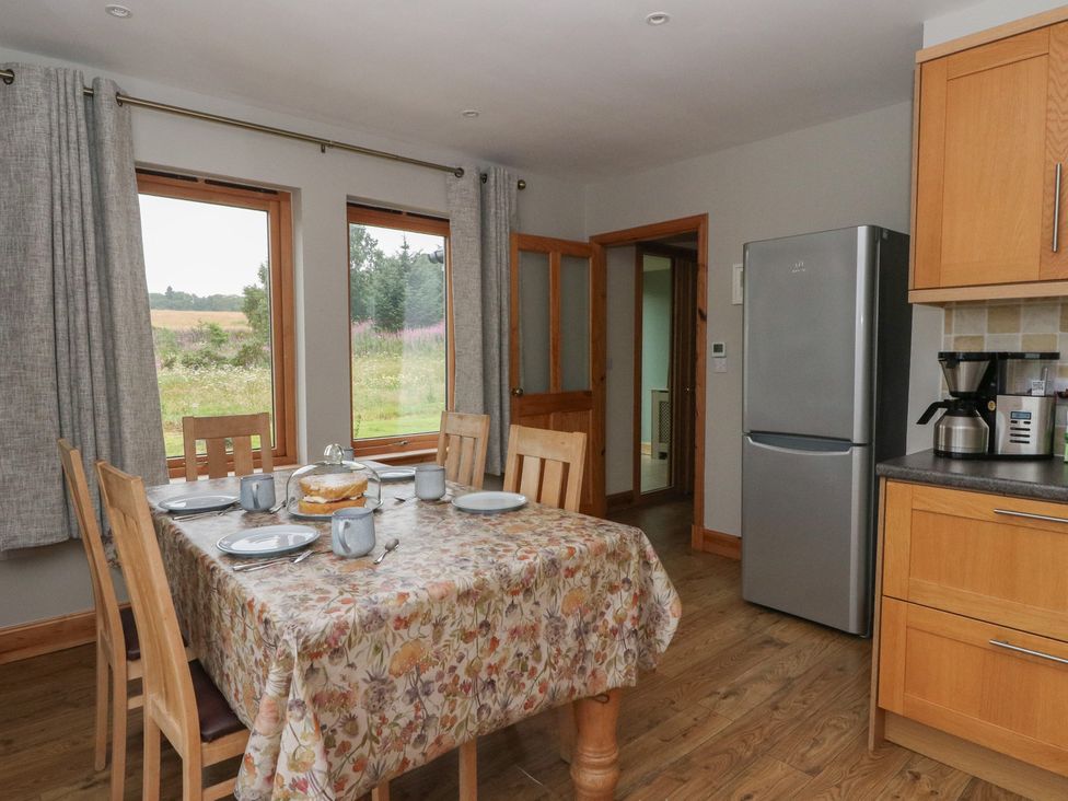 A kitchen with dining table set for breakfast at Taffs Barn Fortrose near Rosemarkie