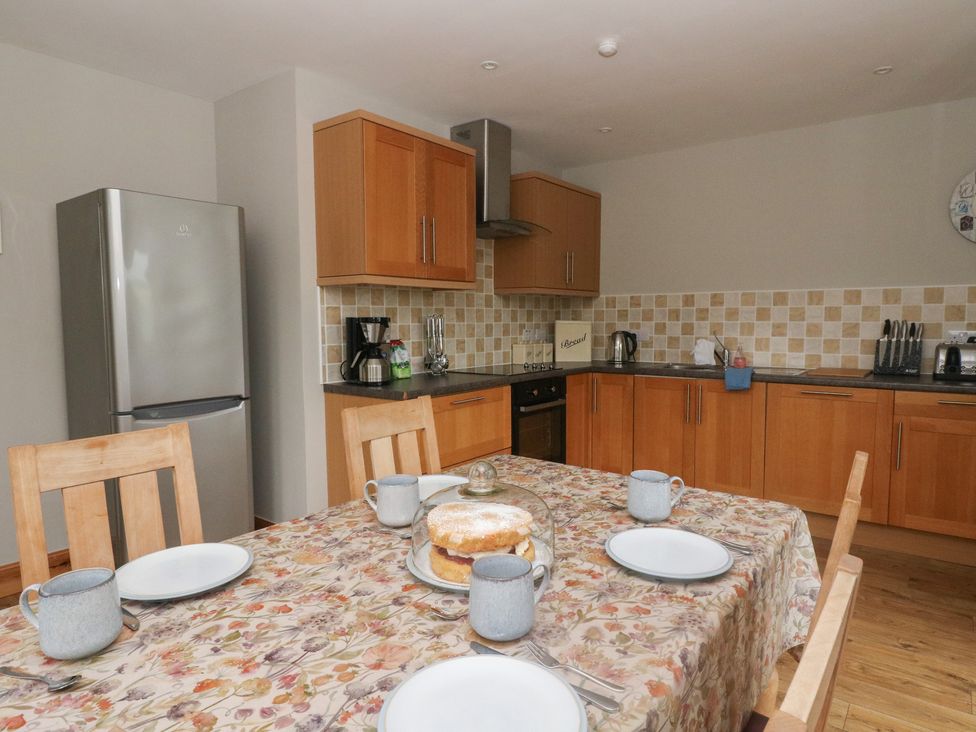 A kitchen with a table set for tea at Taffs Barn Fortrose near Rosemarkie