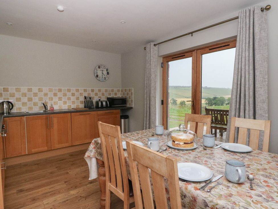 A kitchen with a dining table and chairs at Taffs Barn Fortrose near Rosemarkie