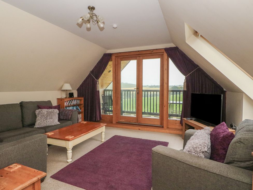A living room with sofas and a coffee table at Taffs Barn Fortrose near Rosemarkie