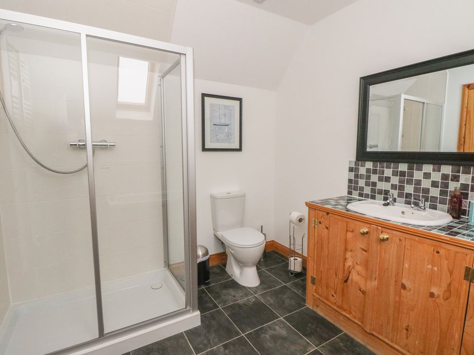A bathroom with a shower, toilet, and sink at Taffs Barn Fortrose near Rosemarkie