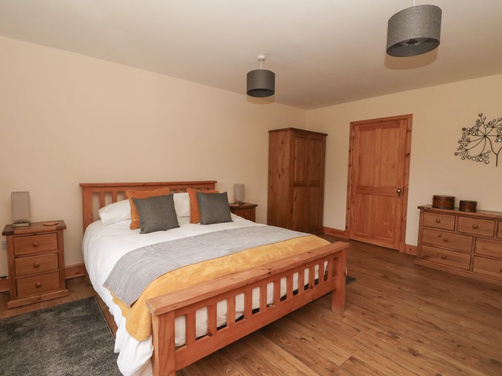 A bedroom with a bed and furniture at Taffs Barn Fortrose near Rosemarkie