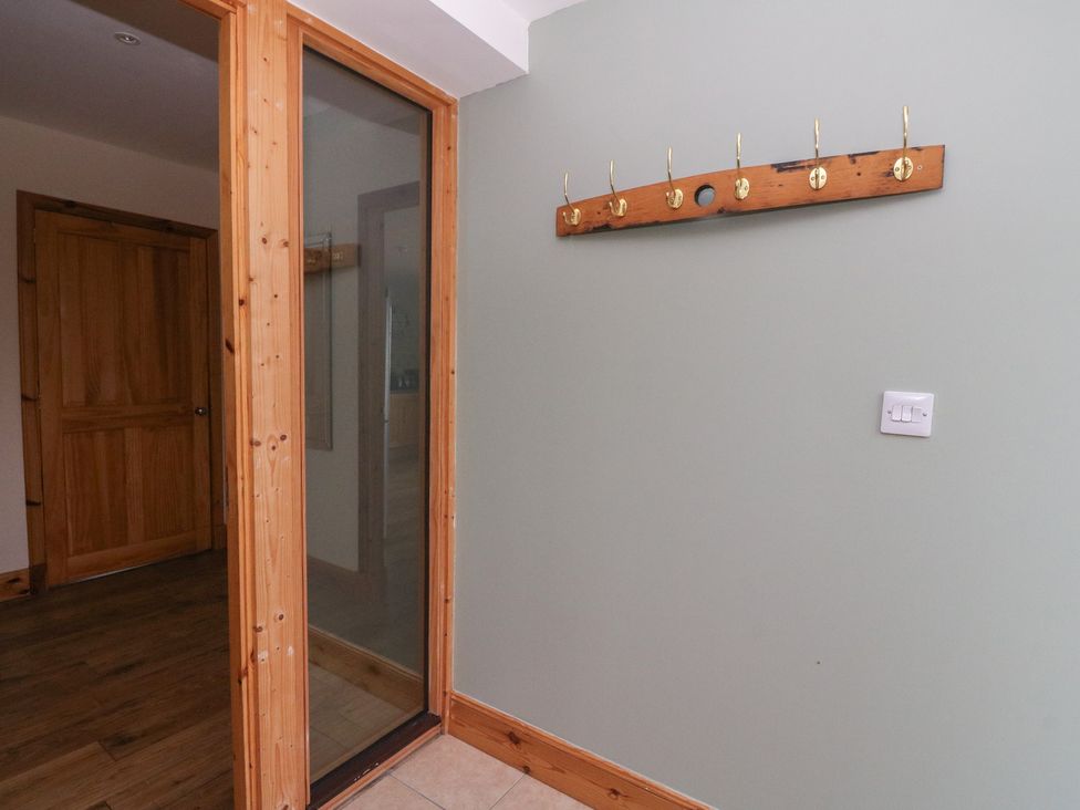A hallway with a coat rack on the wall at Taffs Barn Fortrose near Rosemarkie