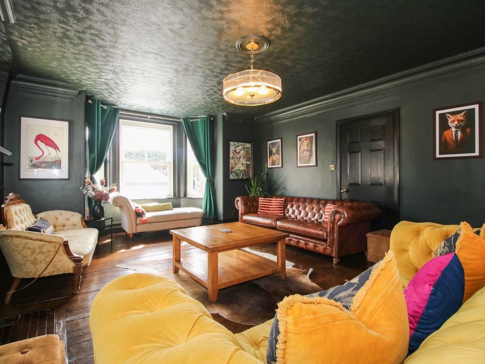 A living room with a sofa and coffee table at The Lodge in Shawbury