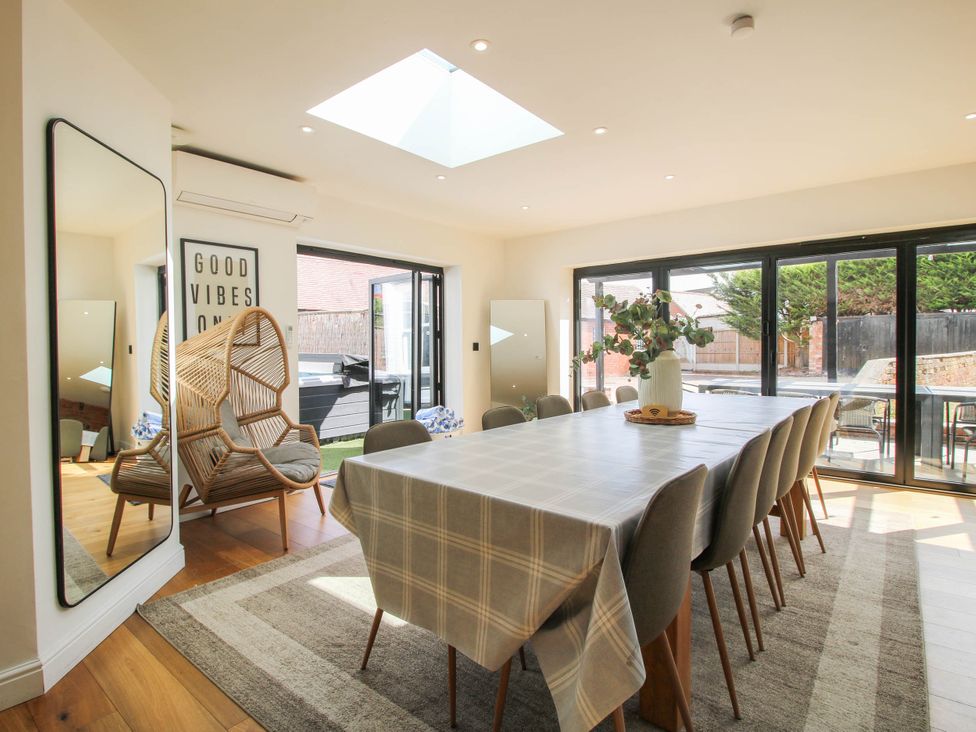 A dining room with a large table and chairs at The Lodge in Shawbury